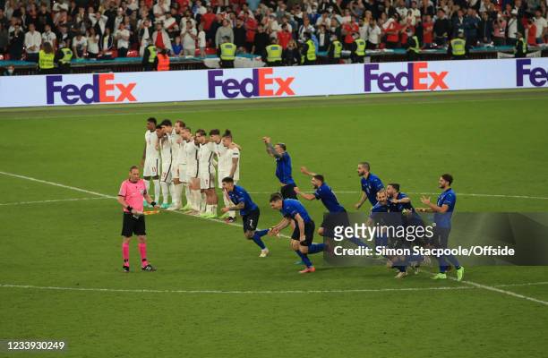 The English players stand still as the Italian players run to celebrate victory in the penalty shootout during the UEFA Euro 2020 Championship Final...