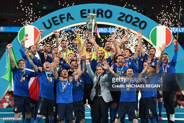 Italy's defender Giorgio Chiellini raises the European Championship trophy during the presentation after Italy won the UEFA EURO 2020 final football...