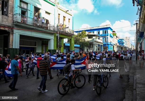 People take part in a demonstration to support the government of the Cuban President Miguel Diaz-Canel in Havana, on July 11, 2021. - Thousands of...