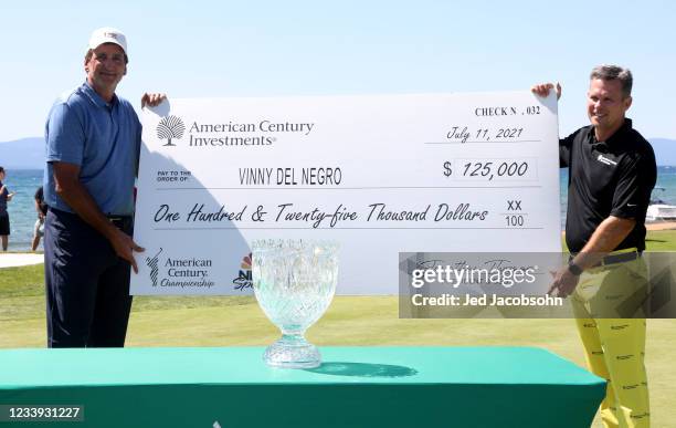 Former NBA player Vinny Del Negro celebrates with a check after winning the final round of the American Century Championship at Edgewood Tahoe South...