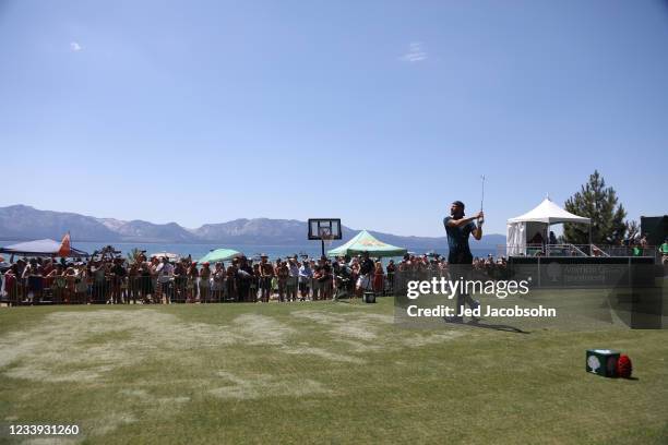 Player Steph Curry tees off on the 17th hole during the final round of the American Century Championship at Edgewood Tahoe South golf course on July...