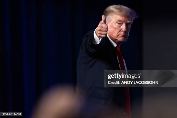 Former US President Donald Trump give a thumbs up as he walks off after speaking at the Conservative Political Action Conference in Dallas, Texas on...