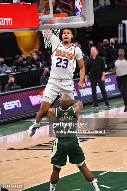 Cameron Johnson of the Phoenix Suns dunks the ball against P.J. Tucker of the Milwaukee Bucks during Game Three of the 2021 NBA Finals on July 11,...