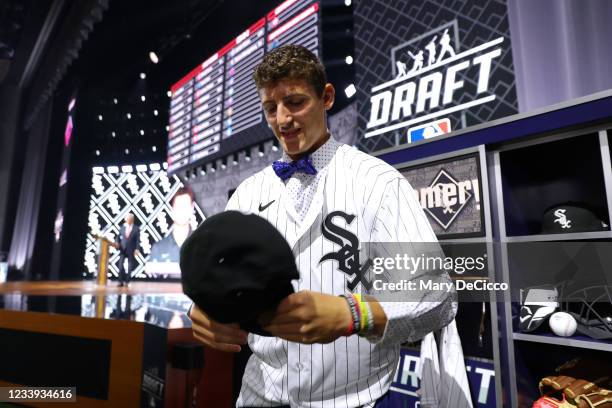 Shortstop Colson Montgomery puts on a cap after being selected 22nd overall by the Chicago White Sox in the first round during the 2021 Major League...