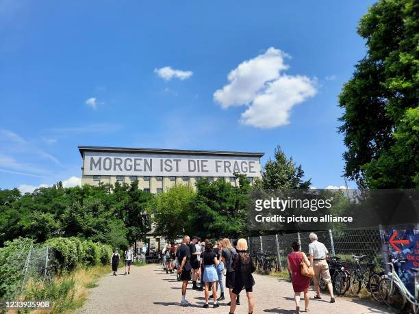 Clubbers wait to be admitted to Club Berghain on Sunday, July 11 with a banner reading "Tomorrow is the question". In the outdoor area, in the...