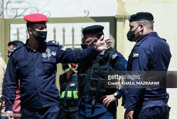 Officers stand guard outside Jordan's State Security Court, as it is set to announce its verdict in the trial of two officials accused of helping...