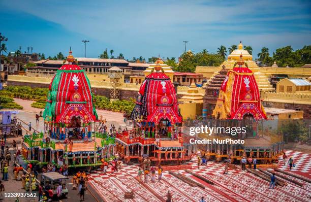 Police personal are seen on the chariot road as traditional temple servitors pulls newly built wooden chariots to set in front of the Shree Jagannath...