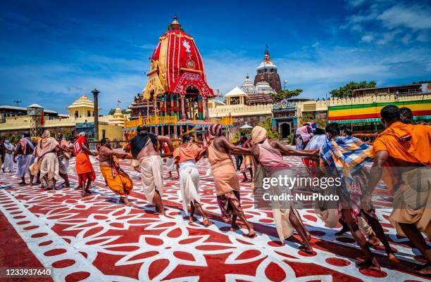 Police personal are seen on the chariot road as traditional temple servitors pulls newly built wooden chariots to set in front of the Shree Jagannath...