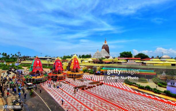 Police personal are seen on the chariot road as traditional temple servitors pulls newly built wooden chariots to set in front of the Shree Jagannath...