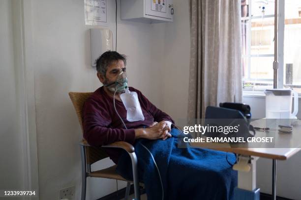 Patient sits in his bedroom in a non-profit COVID-19 care facility in Norwood, Johannesburg on July 12, 2021.