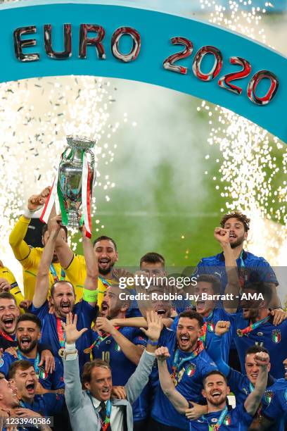 Giorgio Chiellini of Italy celebrates winning EURO 2020 by lifting the trophy aloft with team mates during the UEFA Euro 2020 Championship Final...