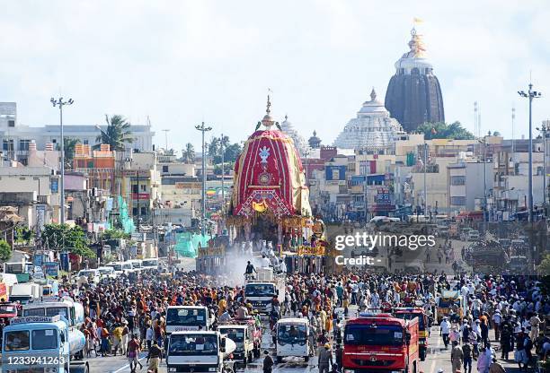 Hindu devotees pull a chariot during the Lord Jagannath Rath Yatra festival in Puri on July 12, 2021.