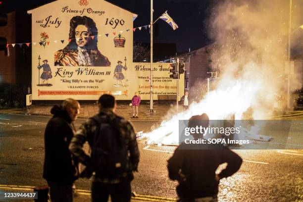 Fire lit in the middle of the street in front of a mural depicting William of Orange in South Belfast. July 11th or 'Eleventh Night' sees a night of...
