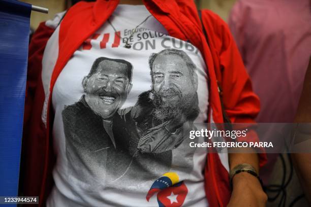 Woman wears a T-shirt with portraits of late Venezuelan President Hugo Chavez and late Cuban leader Fidel Castro, during a demonstration in support...