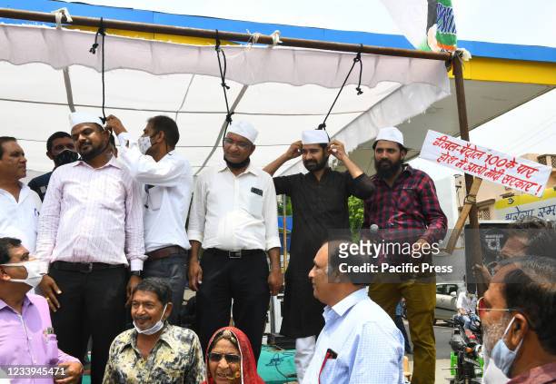 Congress party activists stand with nooses around their neck during protest against Central's Modi Government over continuous hike in prices of...