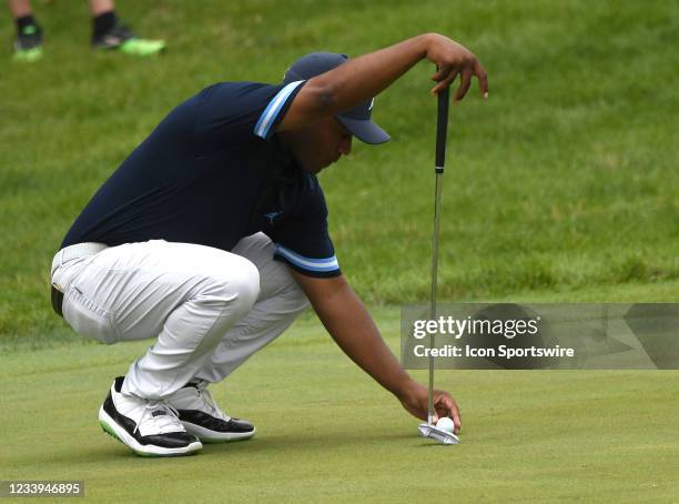 Harold Varner III places his ball on the green during the first round of the John Deere Classic on July 08 at TPC Deere Run, Silvis, IL. ,