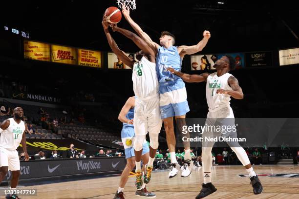 Ekpe Udoh of the Nigeria Men's National Team and Leandro Bolmaro of the Argentina Men's National Team fight for the rebound during the game on July...