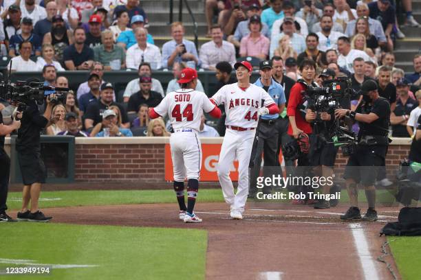 Juan Soto of the Washington Nationals and Shohei Ohtani of the Los Angeles Angels shake hands after the first round during the 2021 T-Mobile Home Run...