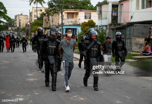 Man is arrested during a demonstration against the government of President Miguel Diaz-Canel in Arroyo Naranjo Municipality, Havana on July 12, 2021....