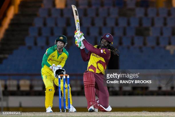 Chris Gayle of West Indies hits 6 as Matthew Wade of Australia watches during the 3rd T20I between Australia and West Indies at Darren Sammy Cricket...