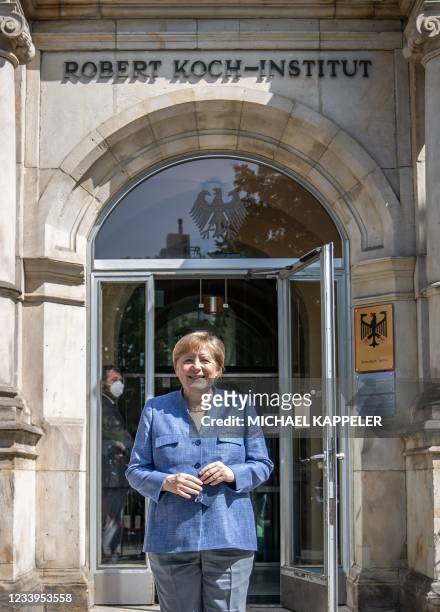 German Chancellor Angela Merkel poses for photographs in front of the Robert-Koch-Institute , during a visit on July 13 amid the ongoing novel...