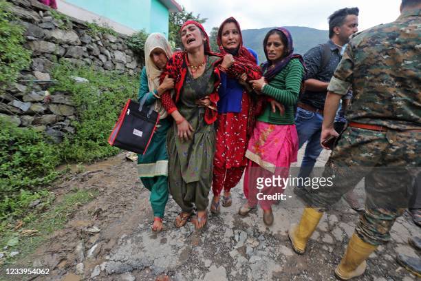 Family members grieve for their missing relatives in a landslide after heavy rains at Boh village in Kangra district of India's Himachal Pradesh...