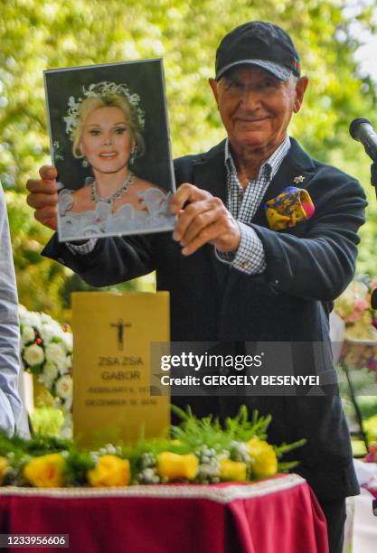 German businessman Frederic Prinz von Anhalt, widower of the Hungarian born US actress Zsa Zsa Gabor shows the portrait of Gabor next to her urn in...
