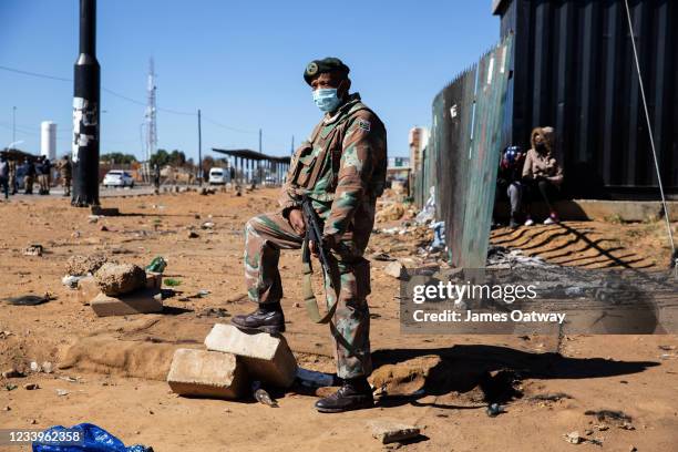South African soldier stands guard while on deployment on July 13, 2021 in Soweto, Johannesburg, South Africa. South Africa has deployed the military...