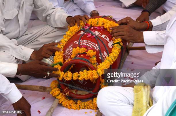 Activists of Congress party demonstrate last rites of a gas cylinder during protest march against Central's Modi Government over high inflation and...