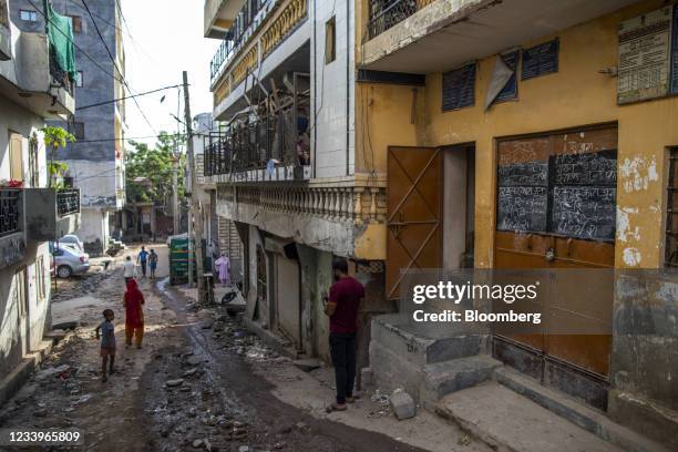 Closed ration store, right, in the Sangam Vihar area of New Delhi, India, on Wednesday, July. 7, 2021. The economic toehold ripped away from legions...