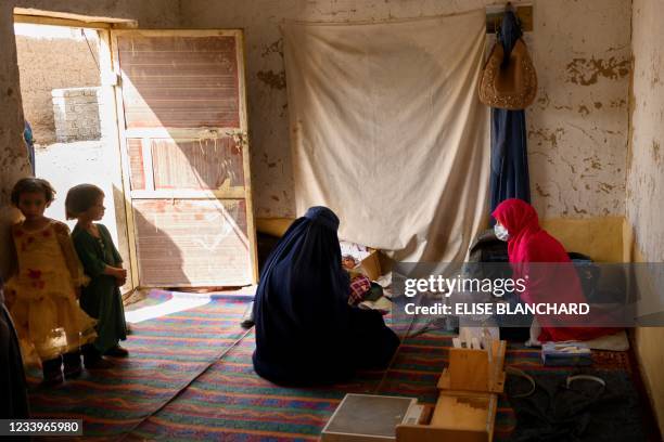 In this picture taken on March 28 a nurse registers a patient at a mobile clinic set up at the residence of a local elder in Yarmuhamad village, near...