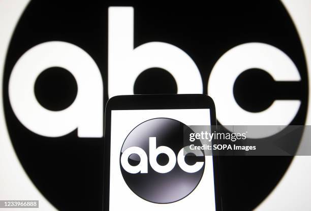 In this photo illustration, ABC logo is seen on a smartphone and a pc screen.