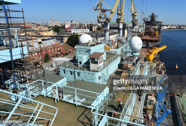 This photograph taken on July 5 shows workers as they work on the deck of Russia's nuclear-powered icebreaker Sibir during construction at the Baltic...