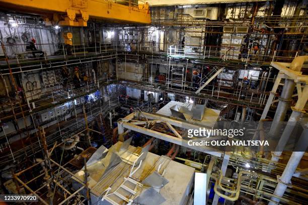 This photograph taken on July 5 shows a worker as they work in the engine hall of Russia's nuclear-powered icebreaker Sibir during construction at...