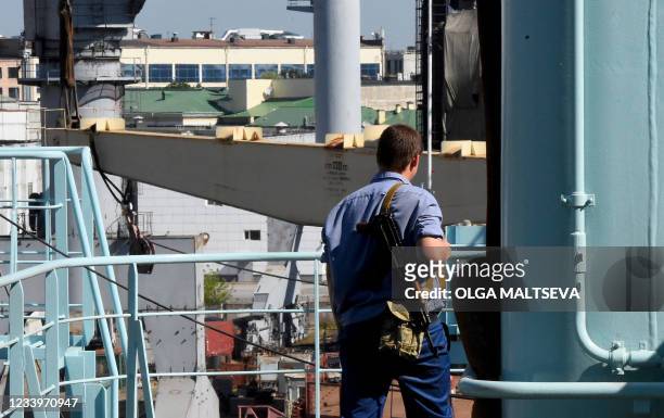 This photograph taken on July 5 shows a security official with a weapon as he patrols on the deck of Russia's nuclear-powered icebreaker Sibir during...