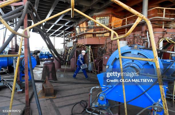 This photograph taken on July 5 shows a worker as he walks on the deck of Russia's nuclear-powered icebreaker Sibir during construction at the Baltic...