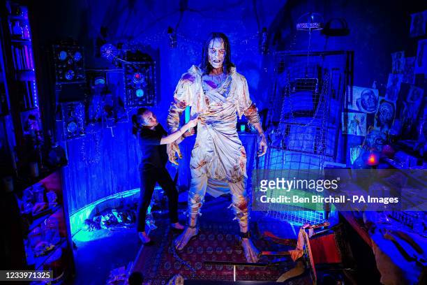 Charlotte Mullen adds the finishing touches to the huge 8-foot tall creature from the gothic horror novel Frankenstein, at the world's first...