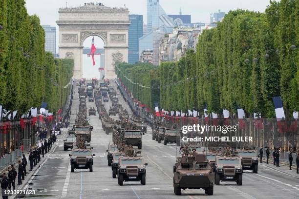 Armored vehicles drive down on the Champs-Elysees avenue during the annual Bastille Day military parade in Paris on July 14, 2021.