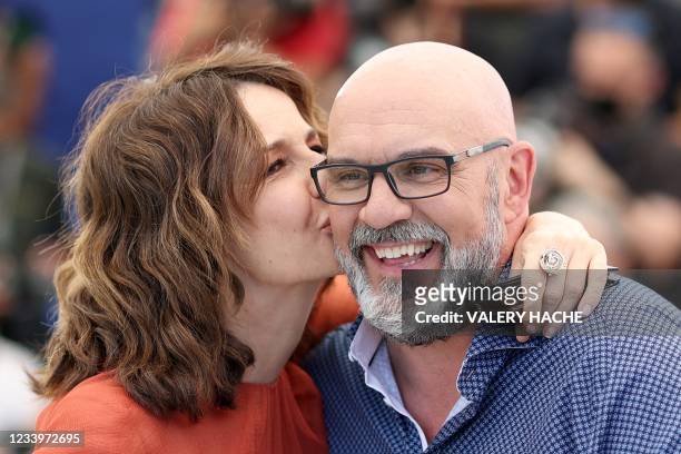 French actress and director Valerie Lemercier kisses Canadian actor Sylvain Marcel during a photocall for the film "Aline, The Voice OF Love" at the...