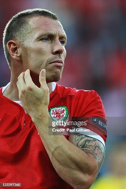 Craig Bellamy of Wales lines up for the national anthems before the UEFA EURO 2012 group G qualifying match between Wales and Montenegro at the...