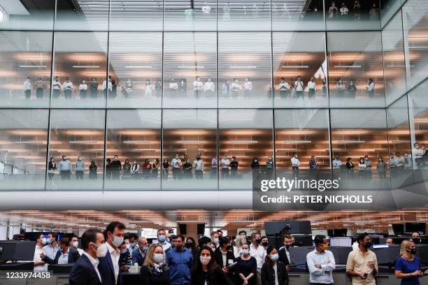 Staff members watch as Britain's Prince Charles, Prince of Wales visits Goldman Sachs headquarters in the City of London on July 14 in recognition of...