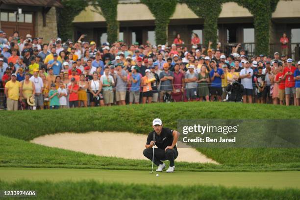 Patrick Cantlay lines up his putt on the 18th green during the final round of the Memorial Tournament presented by Nationwide at Muirfield Village...