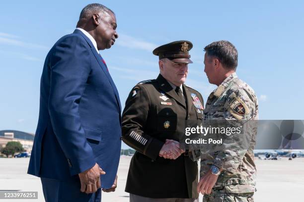 Joint Chiefs Chairman Gen. Mark Milley, center, greets Gen. Scott Miller, the former top U.S. Commander in Afghanistan, right, with the Secretary of...