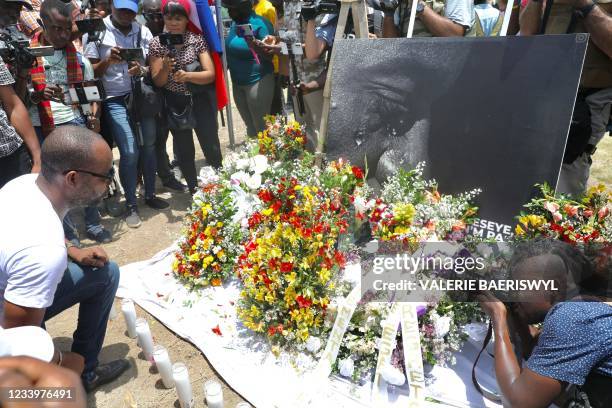 People pay their respects outside of the Presidential Palace in Port-au-Prince on July 14 in the wake of Haitian President Jovenel Moise's...