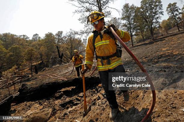 Oakhurst, CaliforniaColby Humphries, left, and Brandon Medina, right, both of the Yolo County Strike Team, put out smoldering patches, remnants of...