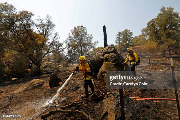 Oakhurst, CaliforniaColby Humphries, left, and Brandon Medina, right, both of the Yolo County Strike Team, put out smoldering patches, remnants of...