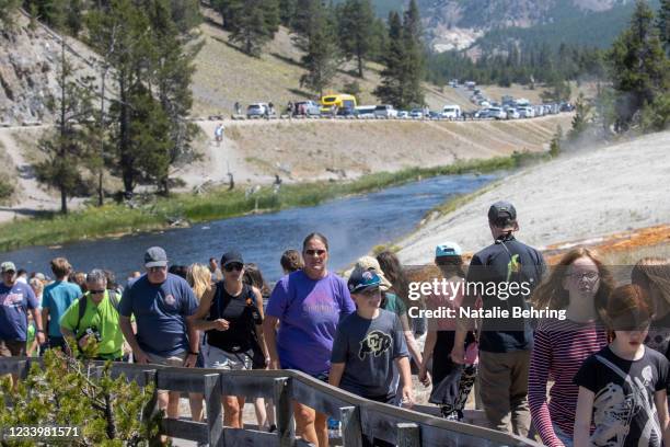 Tourists crowd in to the Midway Geyser Basin July 14, 2021 at Yellowstone National Park, Wyoming. Yellowstone is one of many national parks seeing...