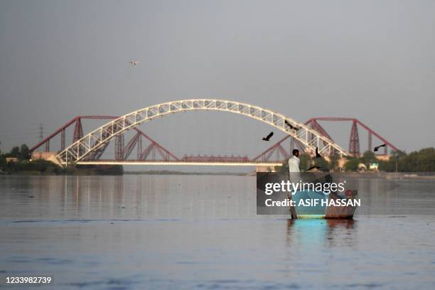 In this photograph taken on March 23 Ghulam Akbar , a local fisherman and volunteer of the Indus river dolphins rescue team, sits on a boat during a...