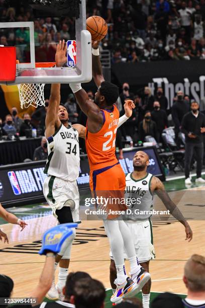 Giannis Antetokounmpo of the Milwaukee Bucks blocks the dunk of Deandre Ayton of the Phoenix Suns during Game Four of the 2021 NBA Finals on July 14,...