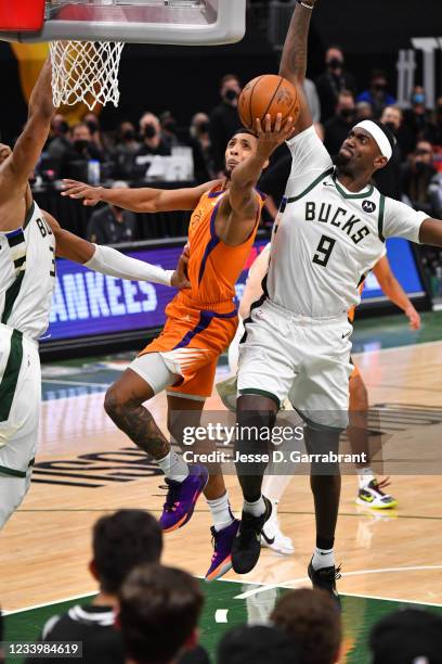 Bobby Portis of the Milwaukee Bucks blocks the shot of Cameron Payne of the Phoenix Suns during Game Four of the 2021 NBA Finals on July 14, 2021 at...